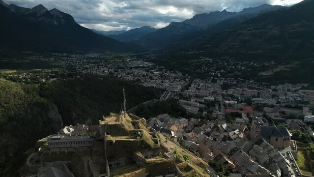 Nice old village with old church at bottom of forested hill, surround with many vineyards. Aerial shot of Briancon, one of France historical towns