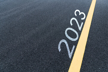 Number 2023 and yellow line on asphalt road