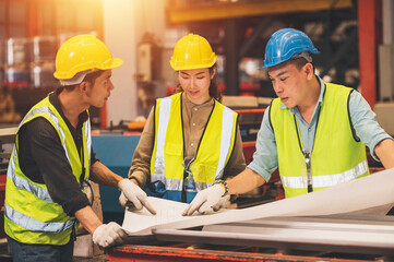 Team Asian engineer working control machine in factory.