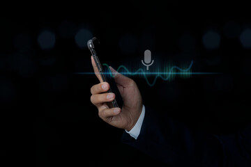 Businessman hand holding smartphone using voice assistant talking to smartphone for access to information.