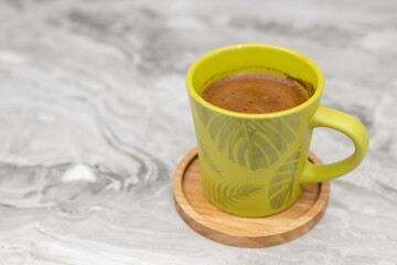 Coffee cup on the wooden coaster