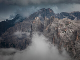 Mountain cliffs at Three Peaks and Paternkofel in the Dolomite Alps in South Tyrol during summer with clouds.