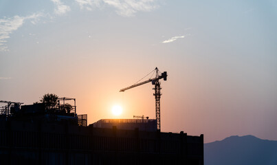 Modern building under construction at sunset