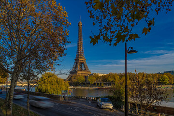 Eiffel Tower Between Fall Colors Trees in a Sunny Day in Paris Seine River and Boats