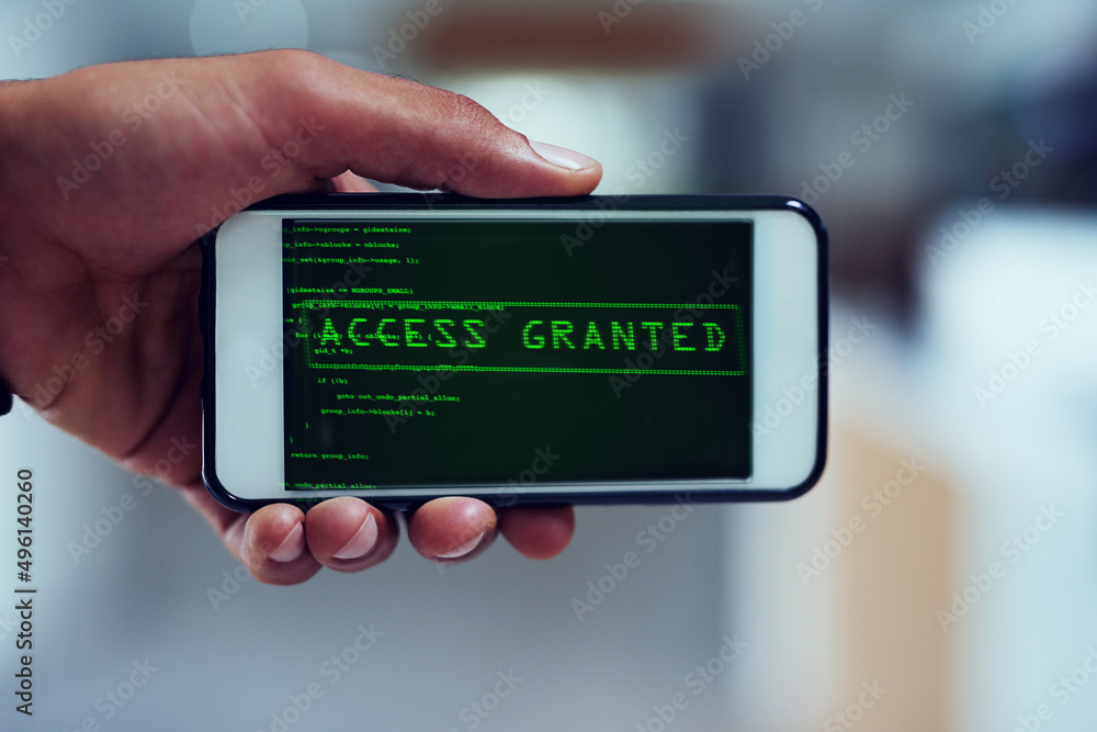 Aufkleber Not even your smartphone is safe. Shot of an unidentifiable man using a smartphone to hack into a computer network.