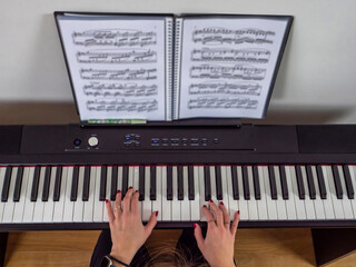 Obraz na płótnie Canvas hands of a woman playing piano