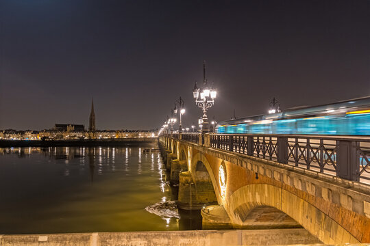 Stone Bridge With Tramway in Bordeaux at Night and Garonne