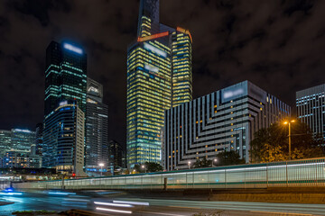 Road Traffic at Night With La Defense Business District Behind Paris Lights Towers