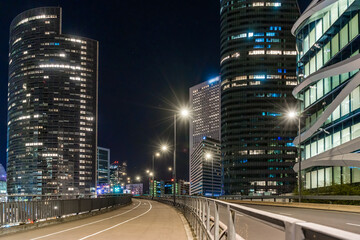 Road Traffic at Night in La Defense Business District Buildings and Towers