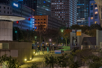 Fototapeta na wymiar Peoples Arriving at La Defense Business District at Night Buildings and Towers