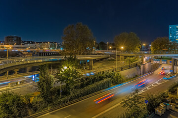 Huge Crossroad at La Defense Business District at Night Vehicles Moving Fast