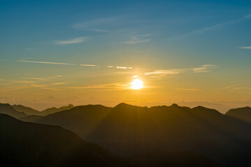 Fototapeta na wymiar Yellow Sky at Sunrise Over French Alps Silhouette