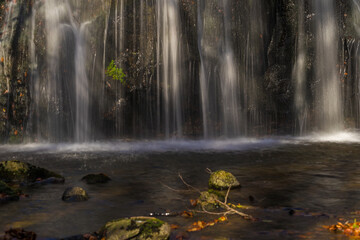 Waterfall With Lights and Shadows Rocks in the River