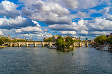 Fototapeta na wymiar Sunny and Cloudy Day over Paris Center Seine River and Bridges Boats Architecture Trees