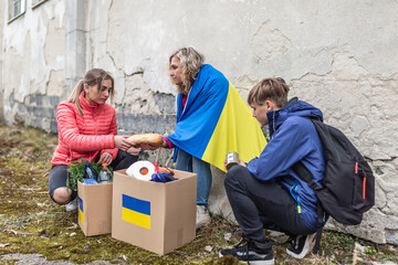 Mom and her children share bread from a package of humanitarian aid that arrived in Ukraine