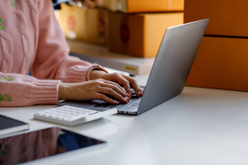 Portrait of Starting small businesses SME owners, two Asian woman check online orders Selling products working with boxs freelance work at home office, sme business online small medium enterprise