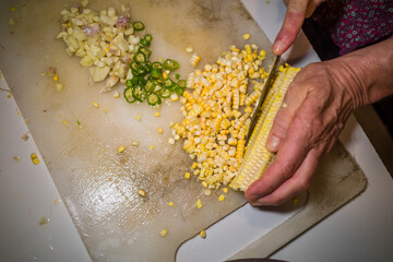 Galle, Sri Lanka Fresh corn is cut from the corn cob for cooking.