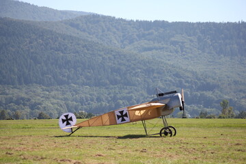 A historic fighter from the time of the first air skirmishes poses against the background of...