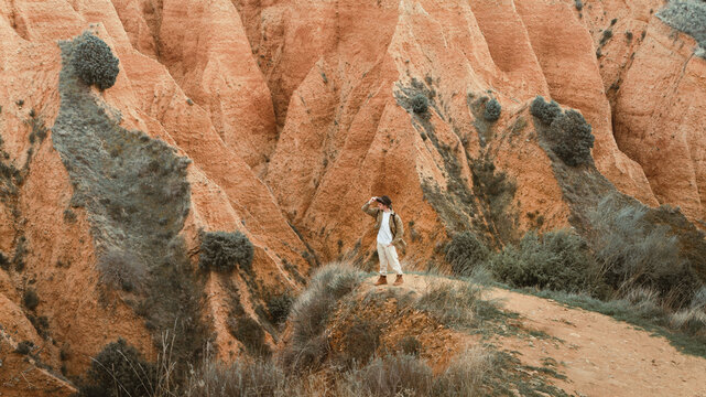 Male traveler admiring rock in nature