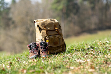Hiking gear. Retro backpack and boots in nature while hiking. Bavarian Forest, Germany.