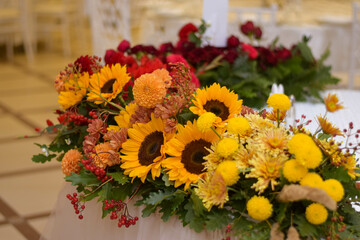 Colourful wedding decorations. Wedding main table with fresh flowers. Sunflower wedding decor. Wedding day.
