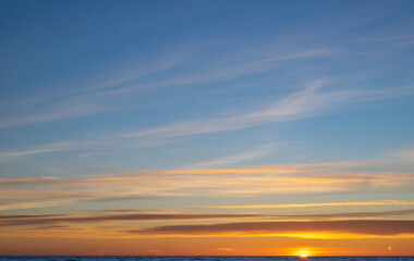 Naklejka na ściany i meble Scenic landscape of sunset sky above sea.