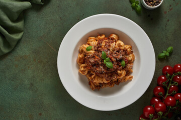 pasta bolognese on a dark green background