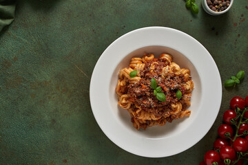 pasta bolognese on a dark green background