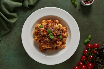 pasta bolognese on a dark green background