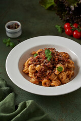 pasta bolognese on a dark green background