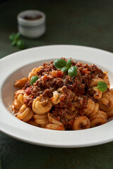 pasta bolognese on a dark green background
