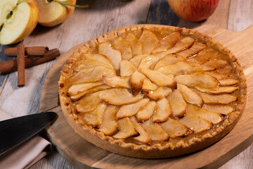 Delicious apple pie on a wooden table, from above