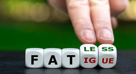 Hand turns dice and changes the word fatigue to fatless.