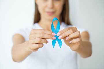Doctor with blue ribbon, prostate cancer awareness