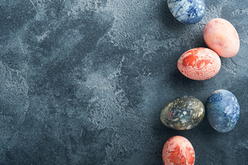 Easter eggs. Dyed Easter eggs with marble stone effect ref and blue color in rustic style on dark...