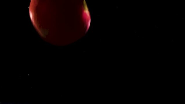 apples fall into water bubbles overlay black 