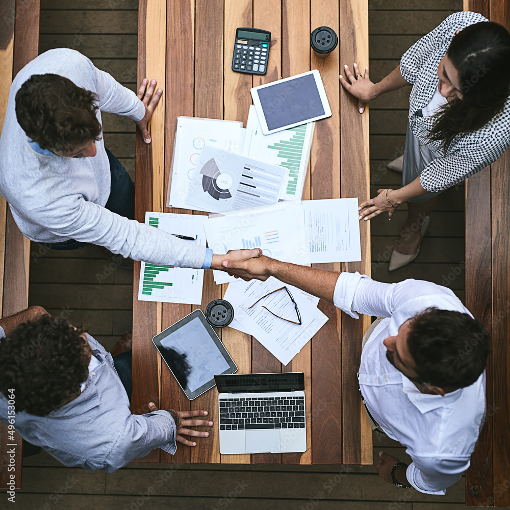 Wall mural Creating the right partnerships is how we will succeed. High angle shot of a team of businesspeople having a meeting outside.