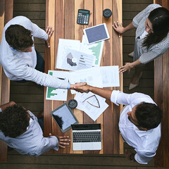 Creating the right partnerships is how we will succeed. High angle shot of a team of businesspeople...
