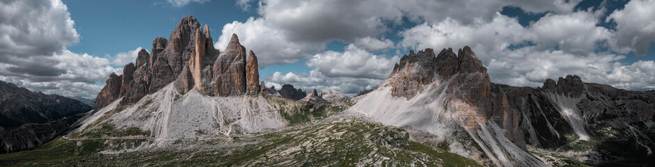 Fototapeta na wymiar Mountain panorama with Three Peaks mountain summits and Paternkofel in the Dolomite Alps in South Tyrol with clouds in blue sky.
