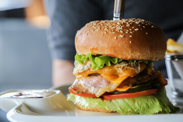 eating tasty grilled prawn and beef burger