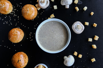Obraz na płótnie Canvas cream soup with mushrooms on black background