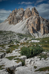 Fototapeta na wymiar Mountain Paternkofel in Three Peaks Nature Reserve in the Dolomite Alps in South Tyrol with clouds in blue sky.