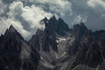 Mountain peaks in the Dolomite Alps in South Tyrol with dramatic cloudy sky, Three Peaks Nature Reserve, Italy.