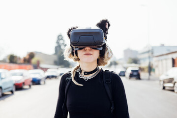 Diverse young nonconformist woman outdoor posing using 3d goggles