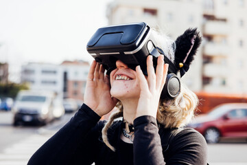 Nonconformist young woman no makeup outdoor smiling using augmented reality headset