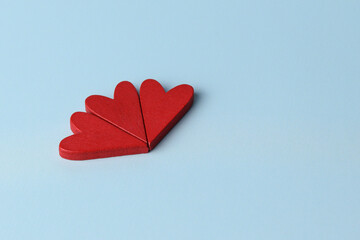 Three red hearts folded into a flower. Wallpaper of love, space for text