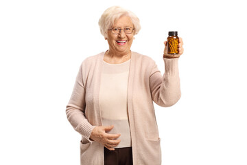 Elderly woman holding a bottle of medications and smiling