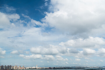 Fototapeta na wymiar The city under cloud blue sky
