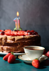 Still life with cake and cup of black tea. Strawberry layer cake close up photo. Beautiful retro styled tableware on a table. Birthday celebration photo.  