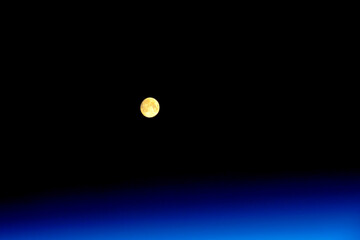 The moon over planet Earth atmosphere. Digital enhancement. Elements by NASA